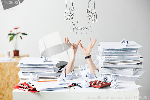 Image of The many crumpled papers on desk of stressed male workplace