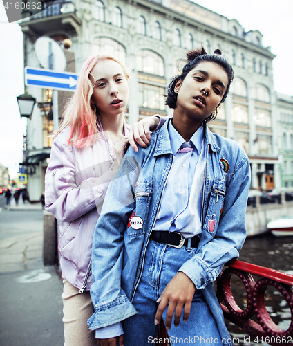 Image of Two teenage girls infront of university building smiling, having