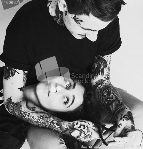 Image of Young couple together making love, hugging. guy with tattoo, gir