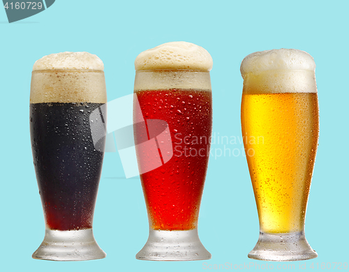 Image of various beer glasses on blue background