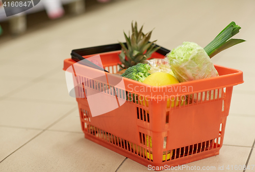 Image of food basket on grocery or supermarket floor
