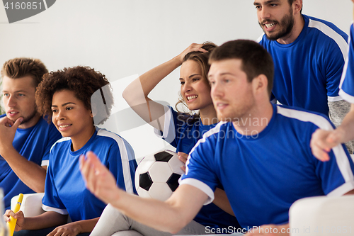 Image of friends or football fans watching soccer at home