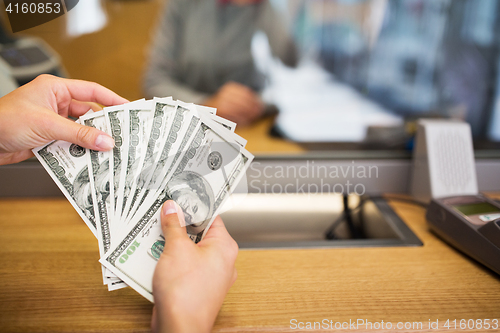 Image of hands with money at bank office or exchanger