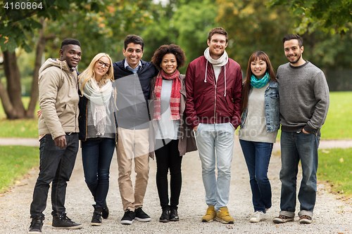 Image of group of happy international friends at park