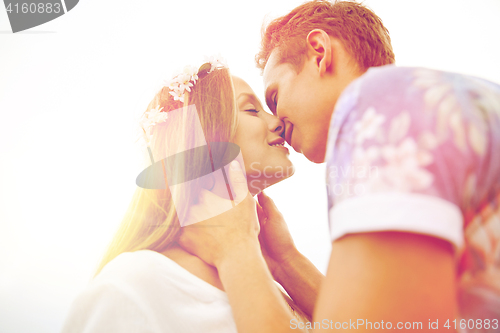 Image of happy smiling young hippie couple kissing outdoors