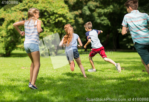 Image of group of happy kids or friends playing outdoors