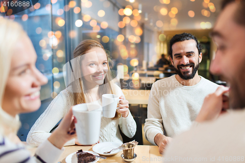 Image of happy friends drinking tea at cafe