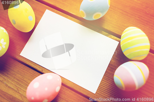 Image of close up of easter eggs and blank white paper