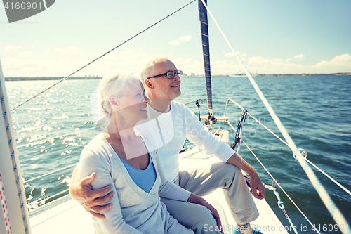 Image of senior couple hugging on sail boat or yacht in sea