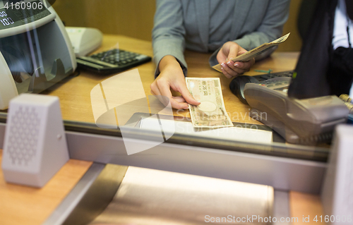 Image of clerk counting cash money at bank office