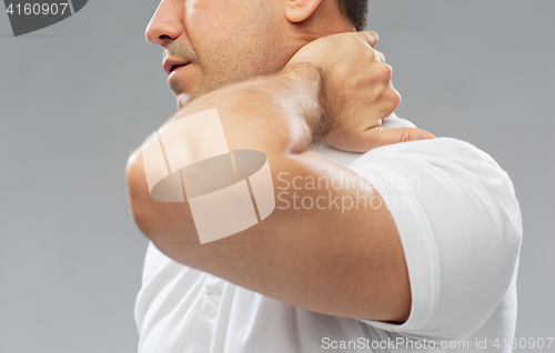 Image of close up of man suffering from neck pain