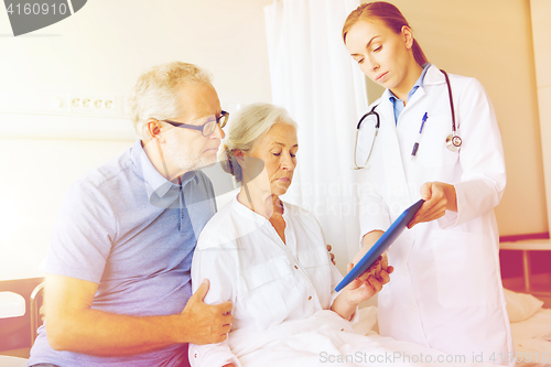 Image of senior woman and doctor with tablet pc at hospital