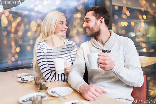 Image of happy couple drinking tea or coffee at cafe