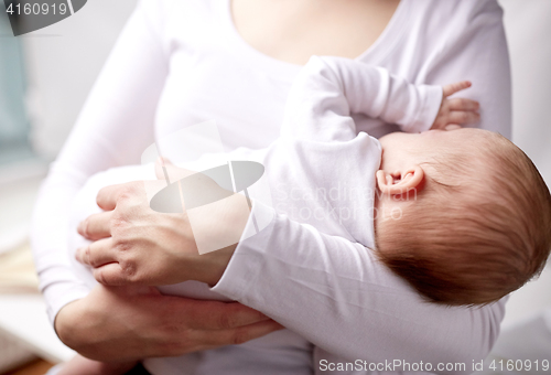 Image of close up of mother holding newborn baby