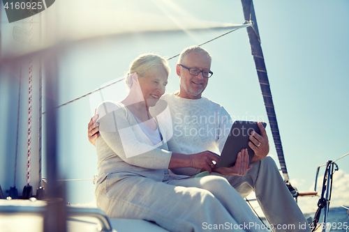 Image of senior couple with tablet pc on sail boat or yacht