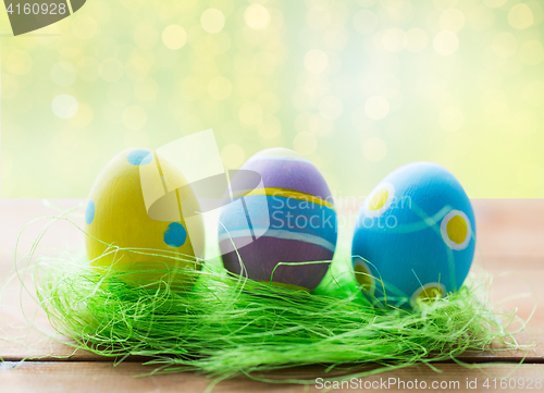 Image of close up of colored easter eggs and grass