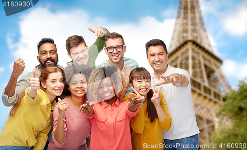 Image of international group of people over eiffel tower