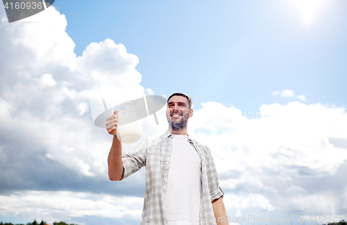 Image of man or farmer with jug of milk at countryside