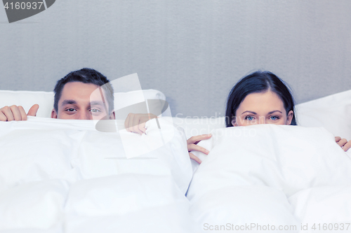 Image of happy couple sleeping in bed