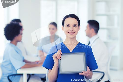 Image of happy doctor over group of medics at hospital