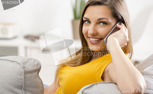 Image of Young woman talking at phone