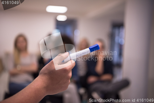 Image of close up of teacher hand with marker