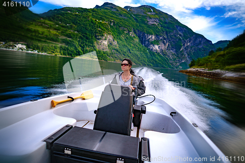 Image of Woman driving a motor boat