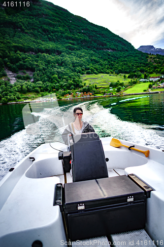 Image of Woman driving a motor boat