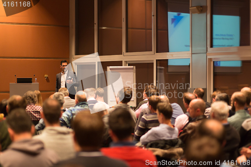 Image of Business speaker giving a talk in conference hall.