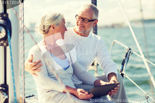 Image of senior couple with tablet pc on sail boat or yacht