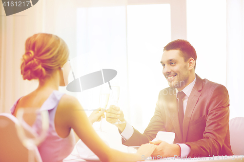 Image of couple with glasses of champagne at restaurant