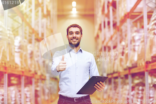 Image of happy man at warehouse showing thumbs up gesture