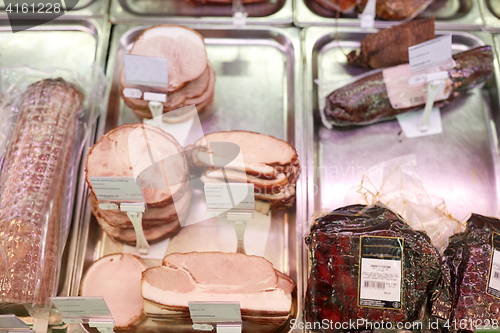 Image of ham at grocery store stall