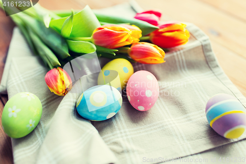 Image of close up of colored easter eggs and flowers