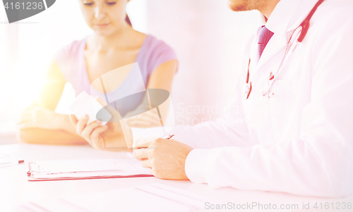 Image of patient and doctor prescribing medication