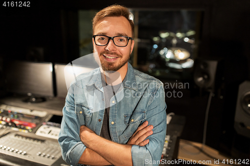 Image of man at mixing console in music recording studio