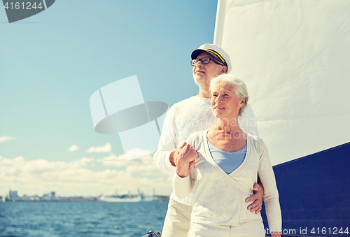 Image of senior couple hugging on sail boat or yacht in sea