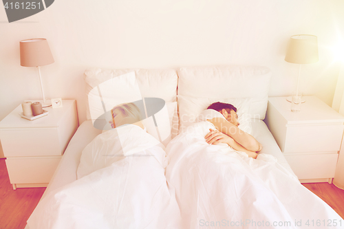 Image of couple sleeping in bed at home