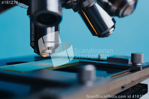 Image of Laboratory Microscope with multiple lenses.