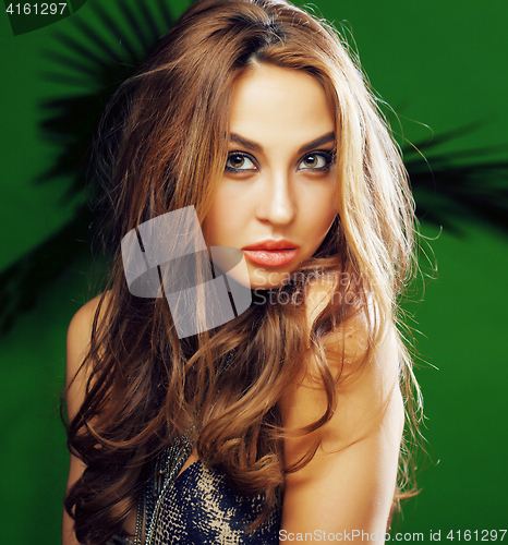 Image of young cute blonde woman on green palm background smiling happy, lifestyle peole concept