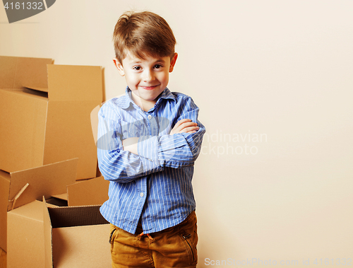 Image of little cute boy in empty room, remoove to new house. home alone,