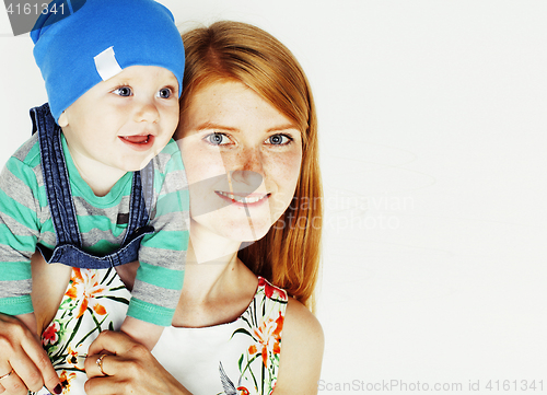 Image of young beauty mother with cute baby, red head happy modern family