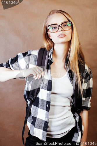 Image of young happy smiling hipster blond girl with backpack ready to sc