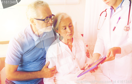 Image of senior woman and doctor with tablet pc at hospital