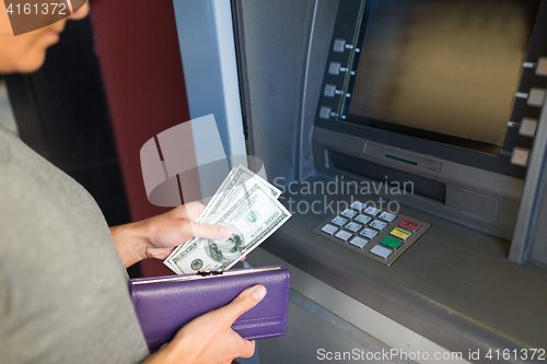 Image of close up of hand withdrawing money at atm machine