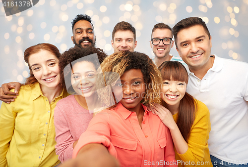 Image of international group of happy people taking selfie