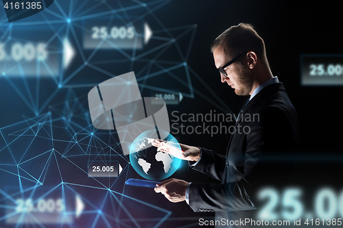 Image of businessman with tablet pc and earth hologram