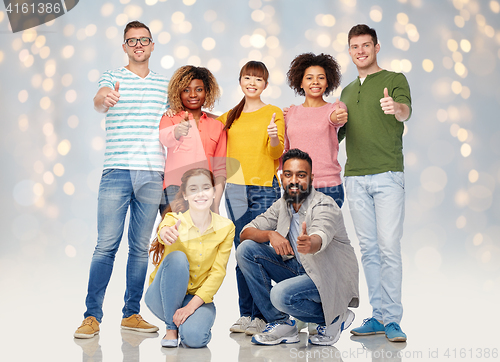 Image of international group of people showing thumbs up