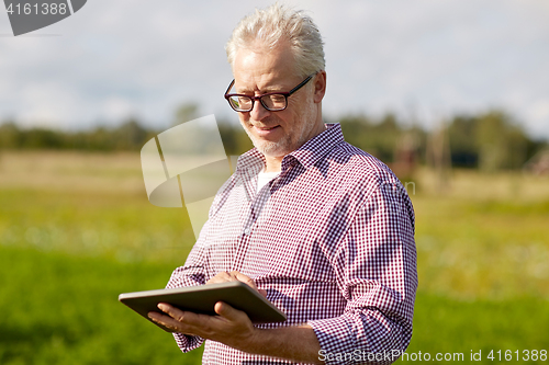 Image of senior man with tablet pc computer at county