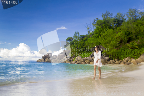 Image of A beautiful woman walking on the beach